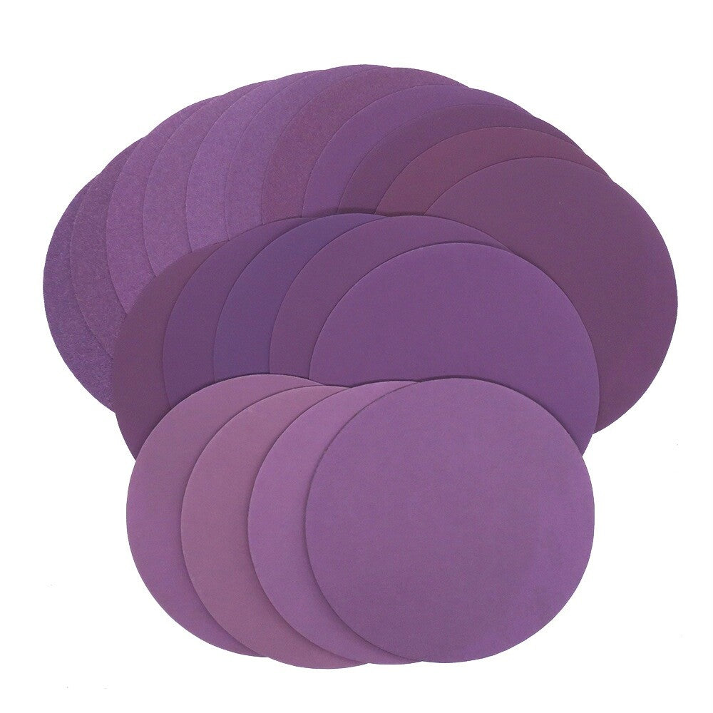 Waterproof sanding discs placed on a wooden surface, ready for use.