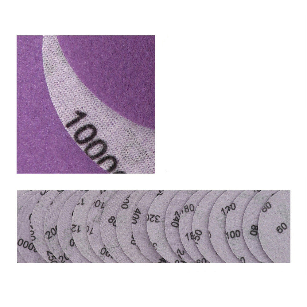 Close-up of a 4-inch 100mm purple sanding disc, showing its waterproof surface and fine grit texture.