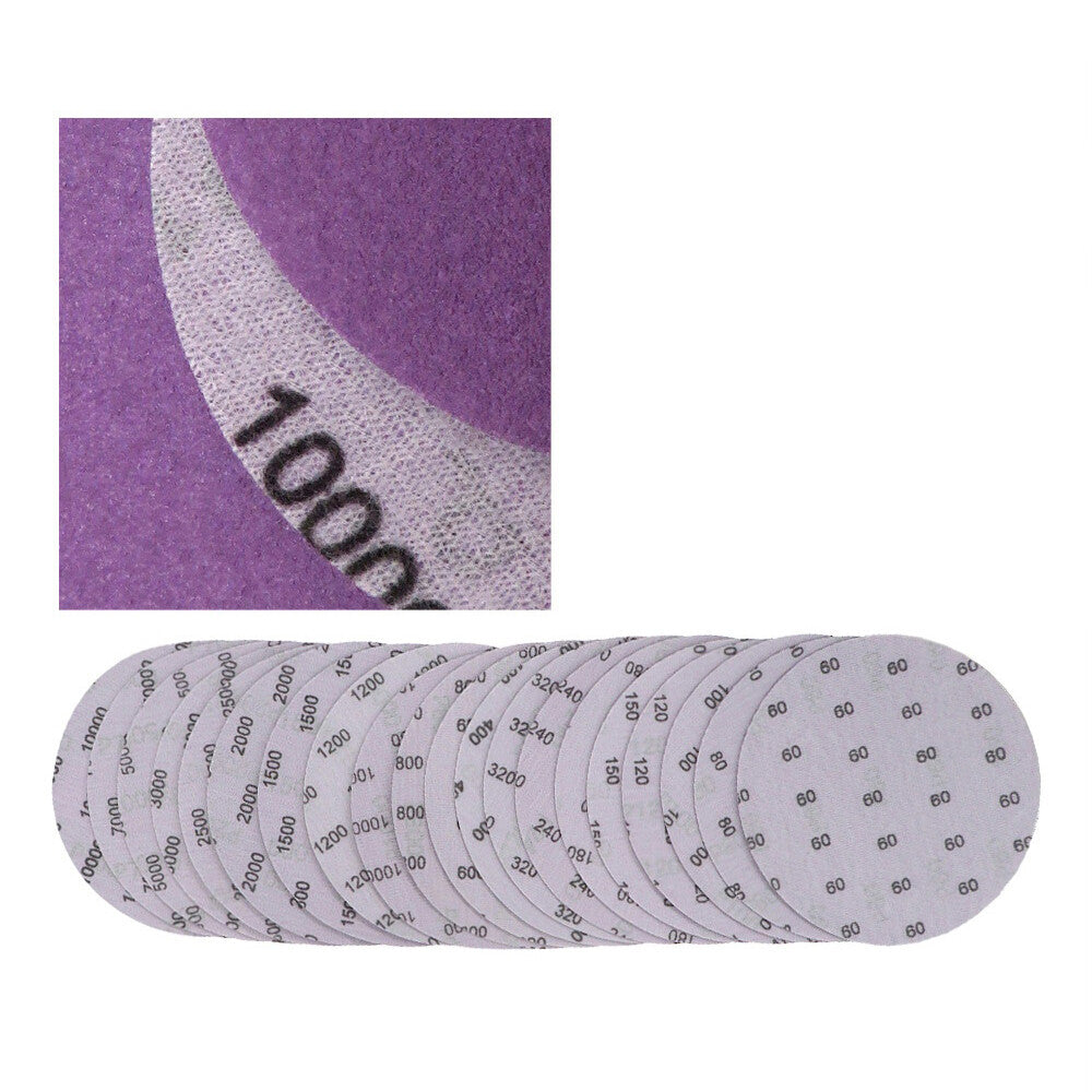 Close-up of a 6-inch purple sanding disc showing its fine grit texture.