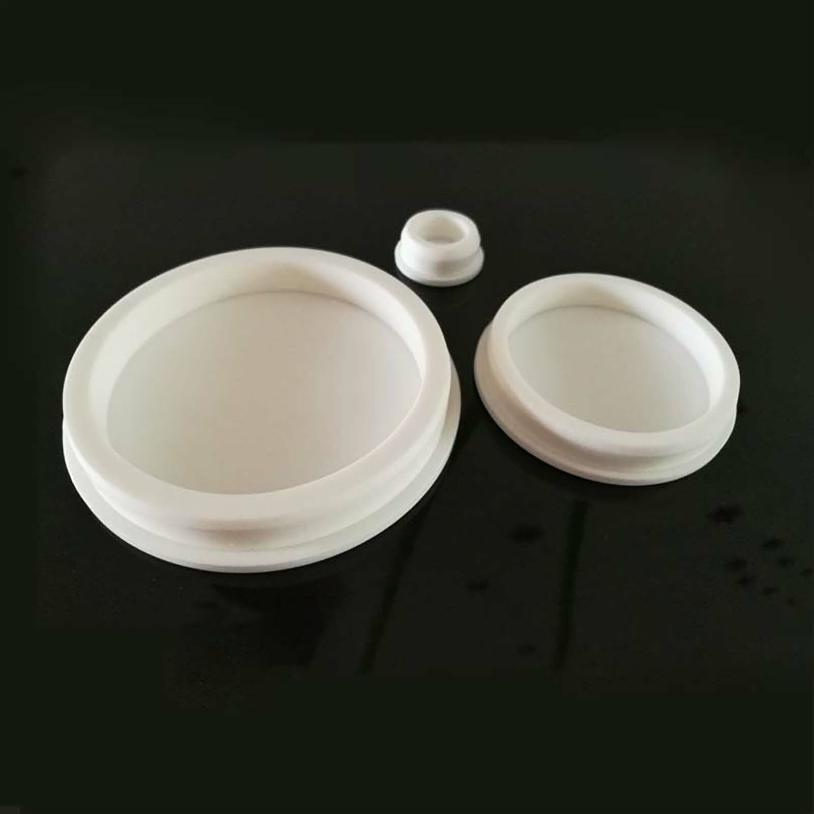 Flexibility test of white silicone hole plug showing easy installation and removal