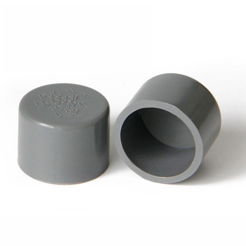 Grey PVC drain pipe cap installed demonstration - waterproof seal shown