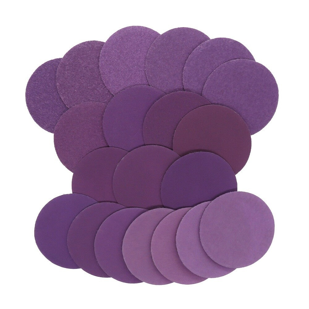 Side view showing the thickness and backing of a purple sanding disc.