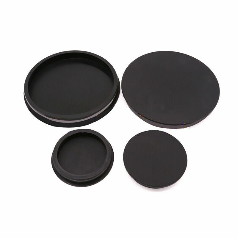 Close-up detail of black PVC pipe plug showing installation groove and rim design