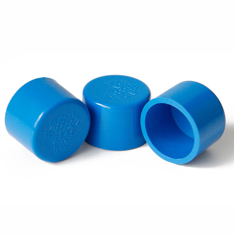Blue PVC end cap installed on drain pipe for watertight protection