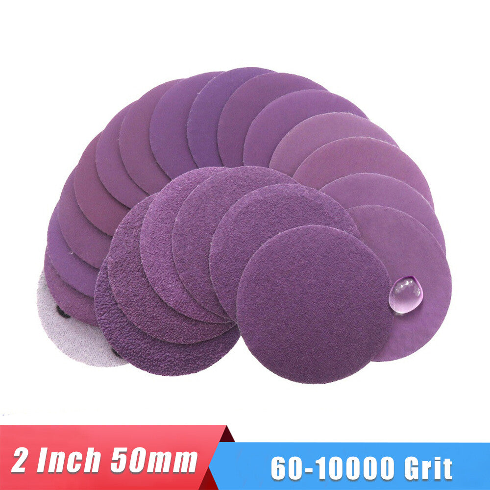 Close-up of a 2-inch purple sanding disc with a grit size visible, perfect for wet or dry sanding