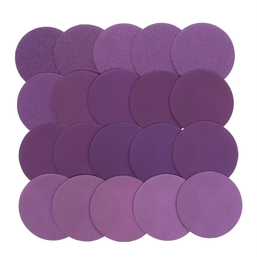 Texture and surface detail of a fine-grit purple sandpaper disc.