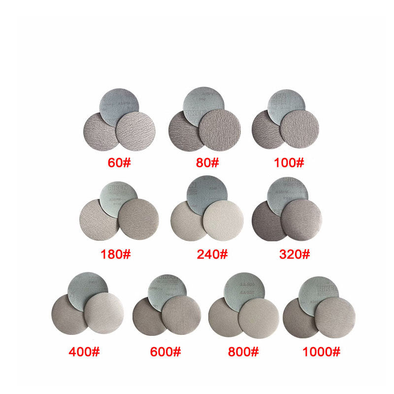 Detailed view showing the abrasive surface and hook and loop backing of a 5-inch sanding disc.