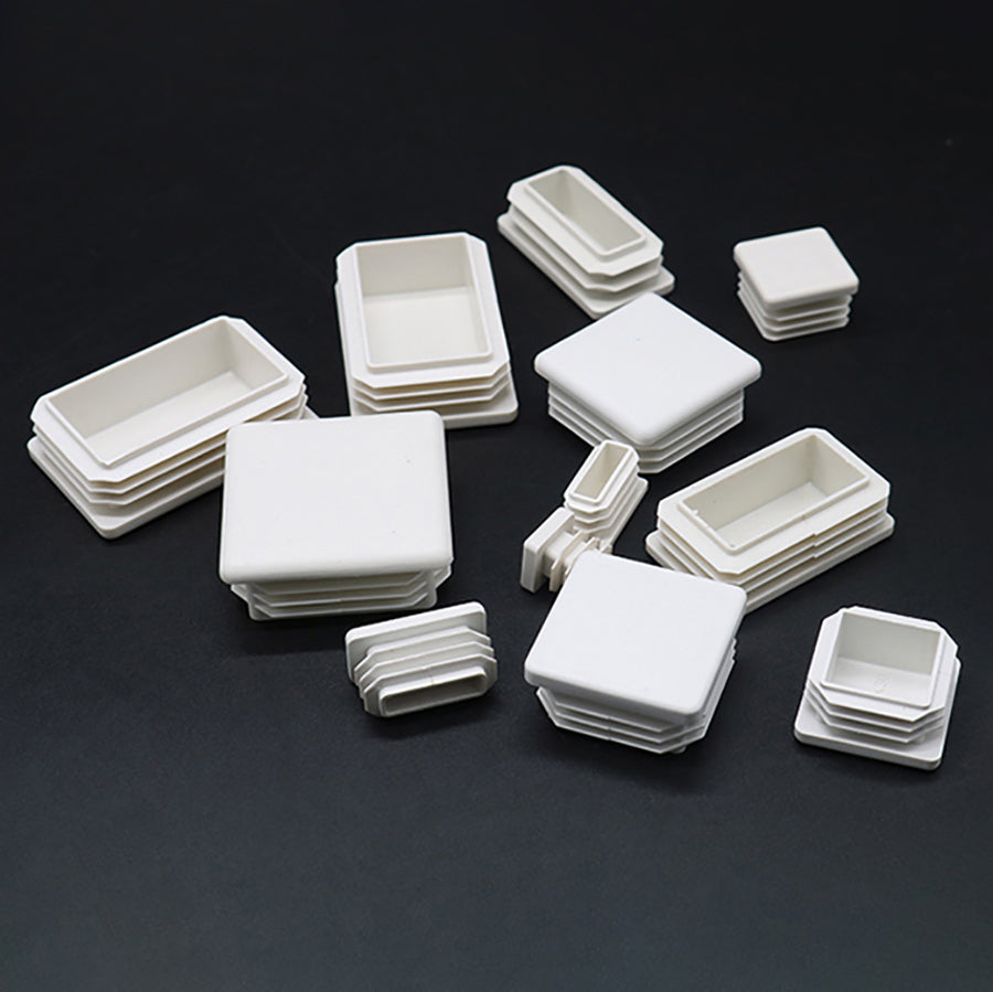 Close-up of white square plastic blanking end caps, durable tube pipe insert plug bungs for visible applications