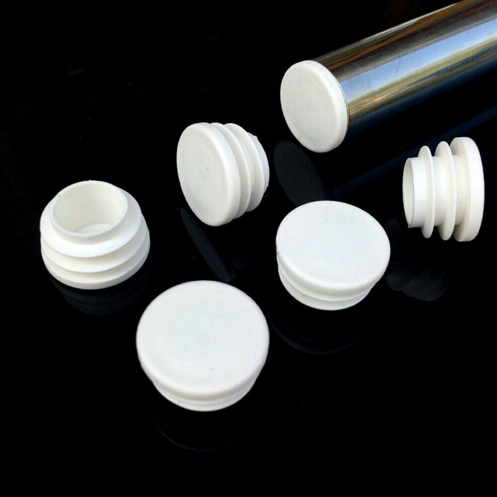Assortment of white round plastic end caps showing size range from 16mm to 50mm