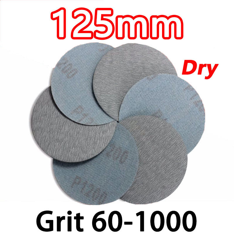 Close-up of a stack of 125mm (5-inch) hook and loop dry sanding discs in various grits from P60 to P1000.