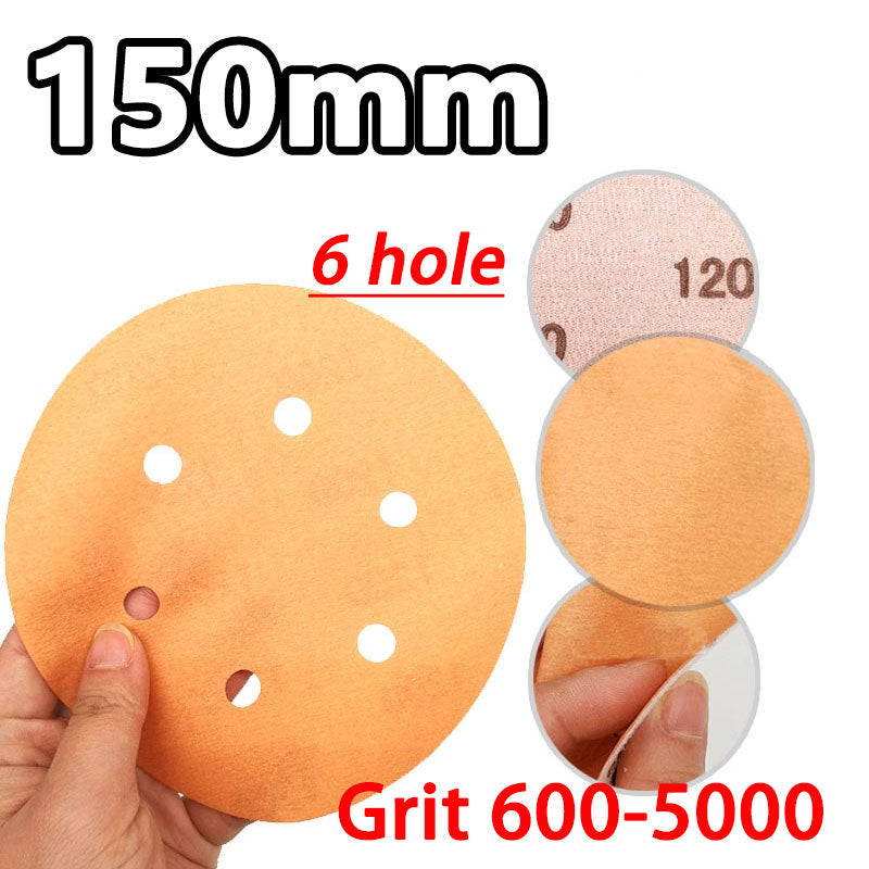Close-up stack of 150mm/6-inch wet dry sanding discs with hook and loop backing and 6 holes for dust extraction.