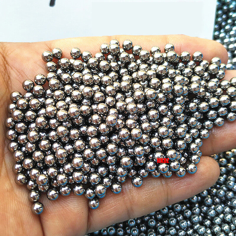 Balls reflecting a sharp light source to demonstrate optical-quality smoothness