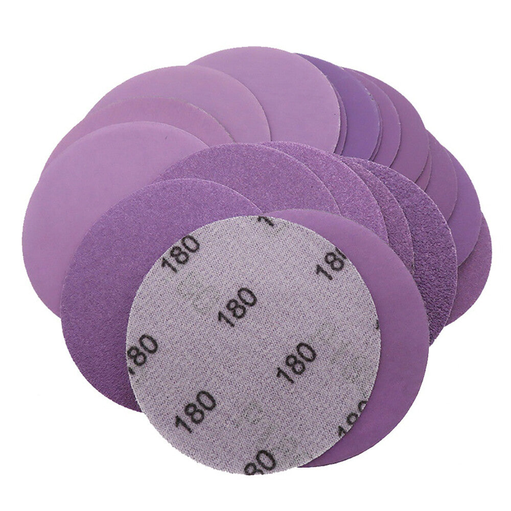 Using a purple wet sanding disc for automotive paint polishing and smoothing.