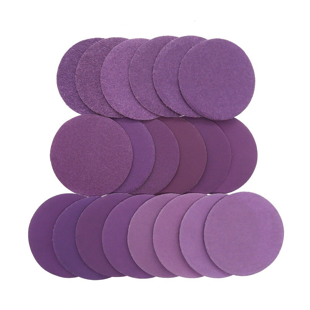 tack of 50mm purple waterproof sandpaper discs showing their uniform thickness and quality.