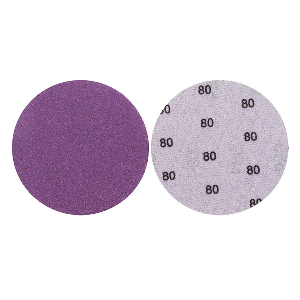 Assortment of 4-inch purple sandpaper discs from coarse 60 grit to very fine 10000 grit for a complete sanding workflow.