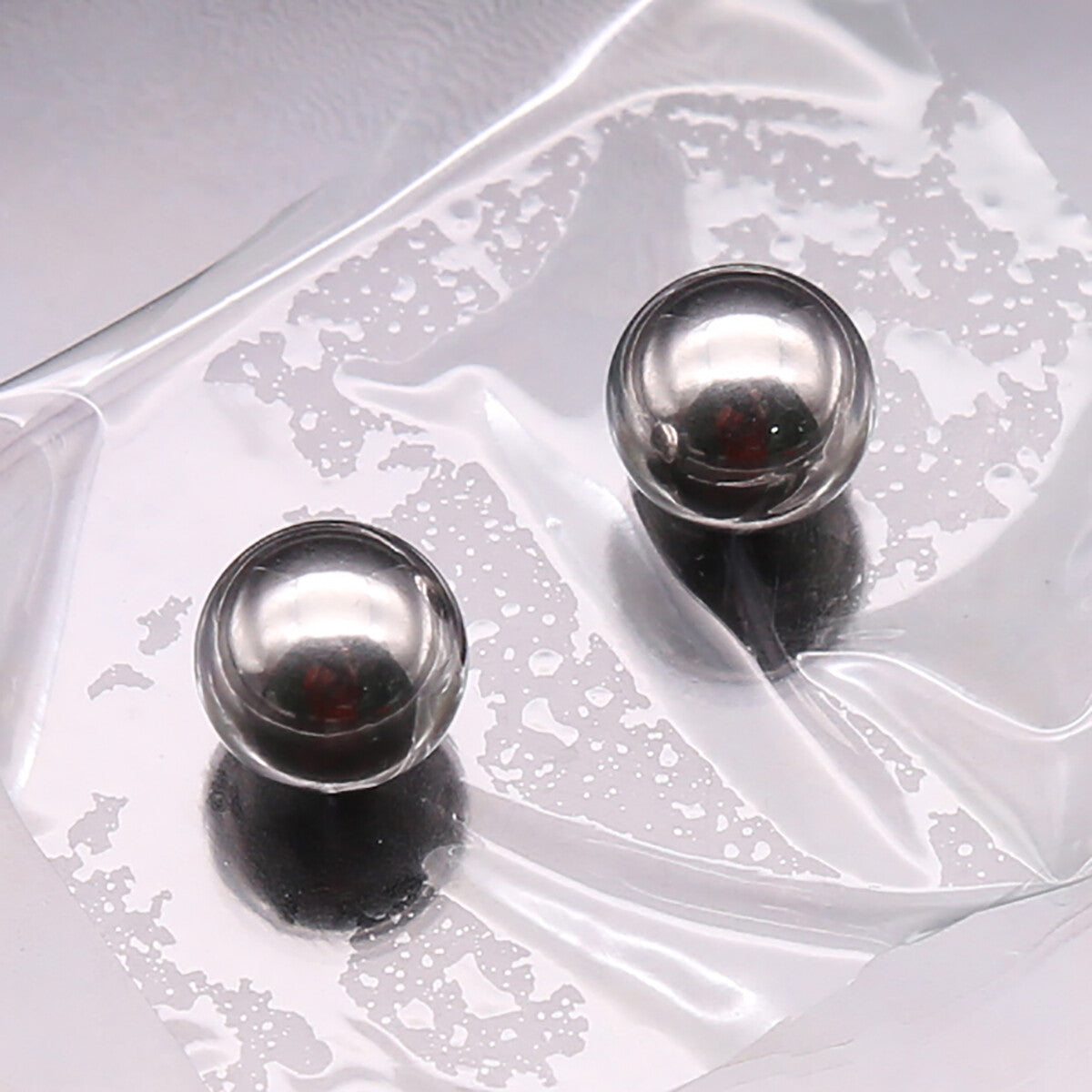 Full assortment of steel balls arranged by size from 1mm to 30mm on a scale