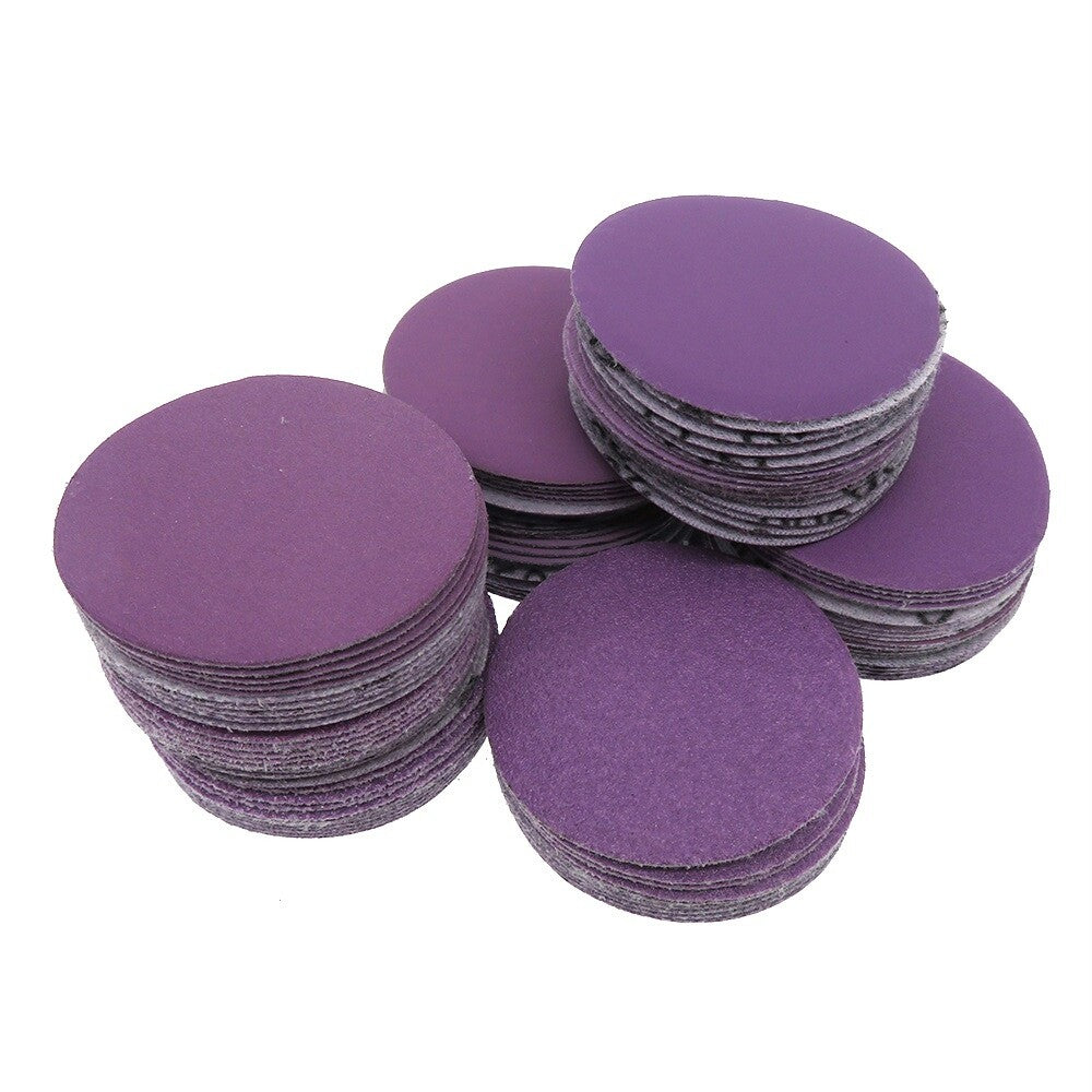 Purple sanding disc attached to a backing pad for power tools.
