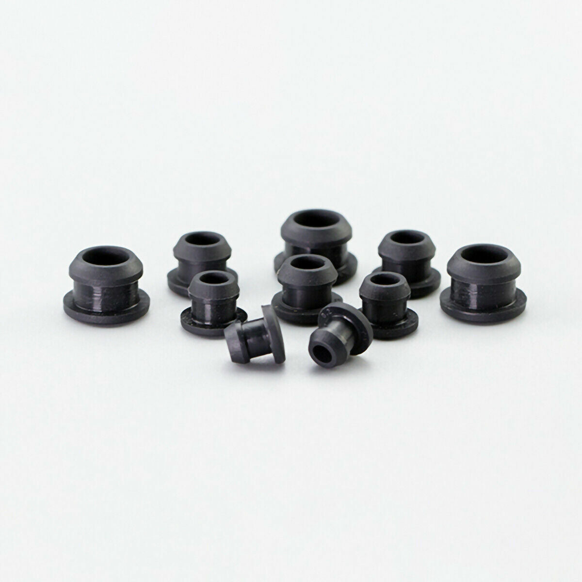 Multiple silicone plugs arranged by size showing gradual diameter increase