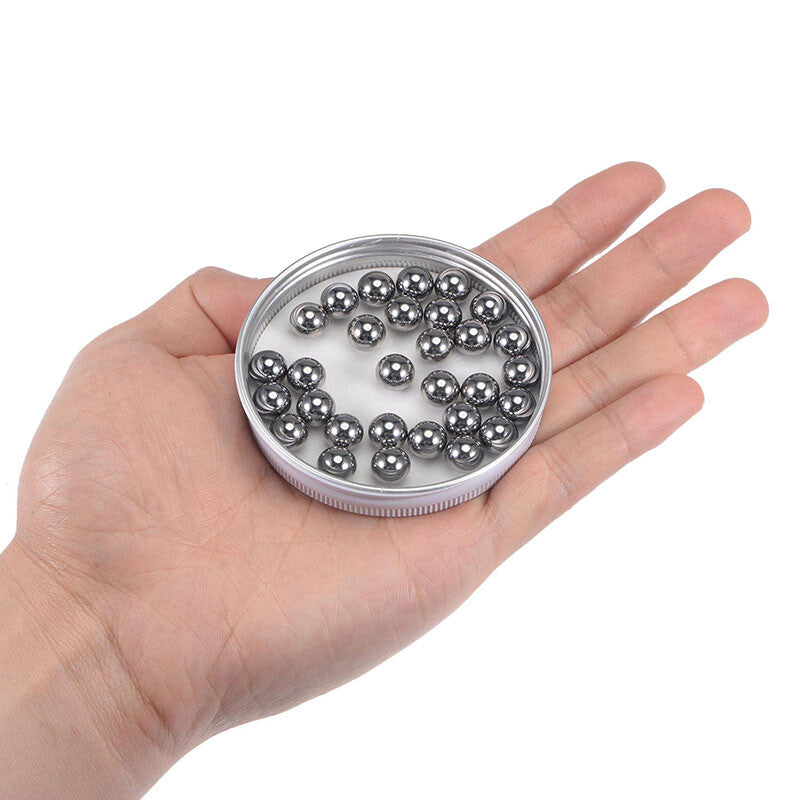 Close-up of 10mm and 11mm stainless steel balls showing precise size difference