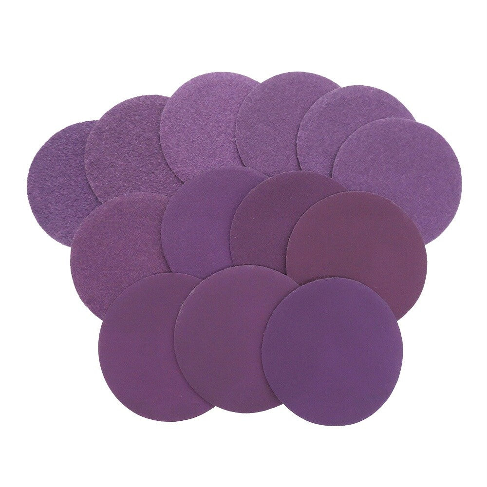 Stack of 50mm purple waterproof sandpaper discs for fine sanding.