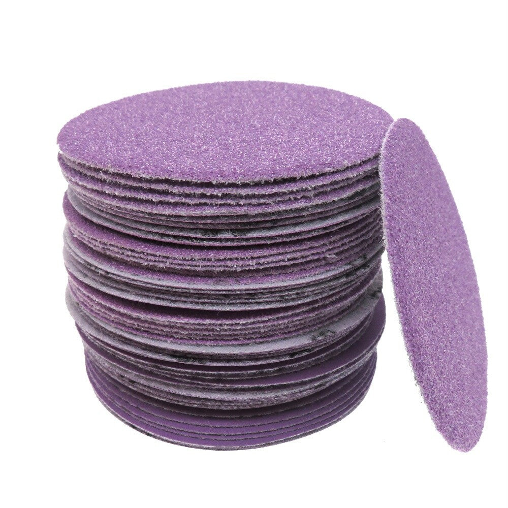 Side-by-side comparison of new and used purple sanding discs showing durability.