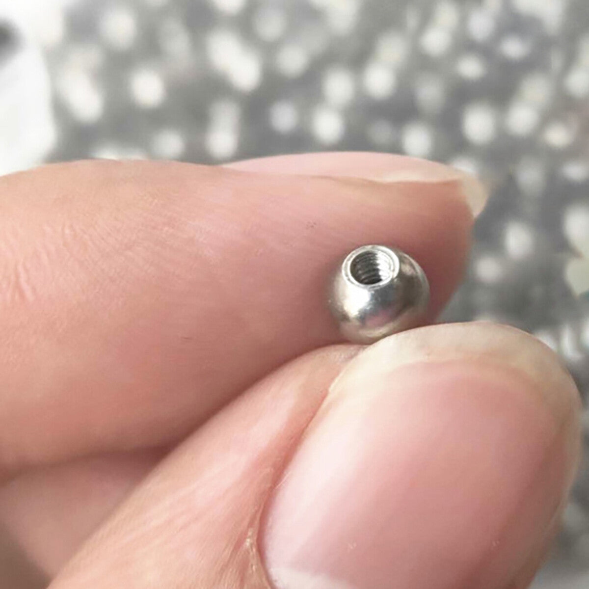 Side-view of half-hole thread ball bearing round balls, highlighting the precision machining and stainless steel material.