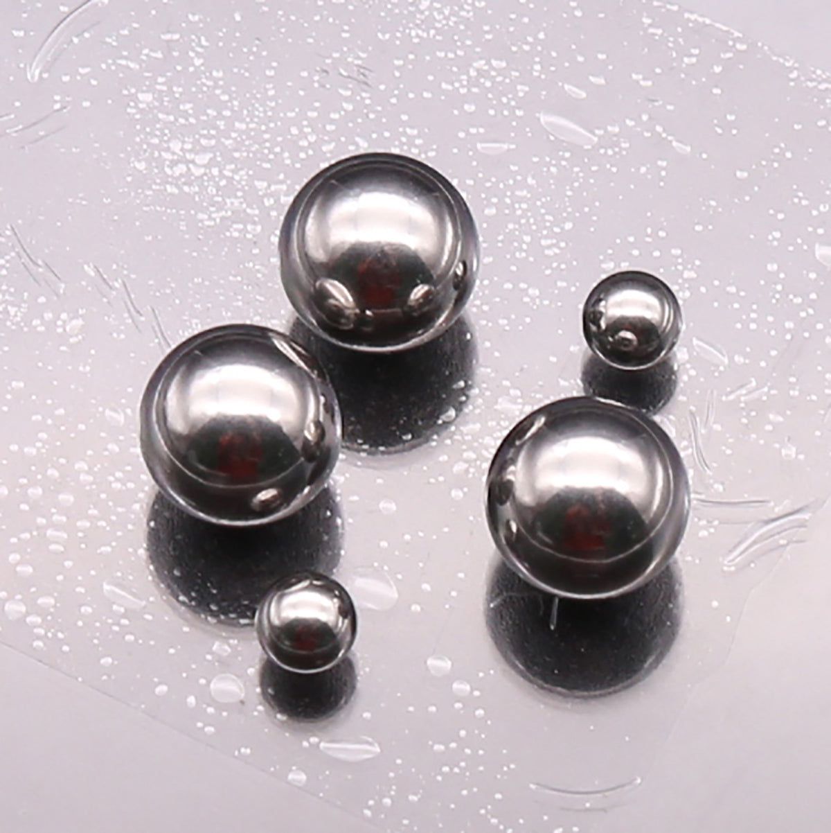 Side-by-side comparison of small (1mm), medium (10mm), and large (25mm) balls