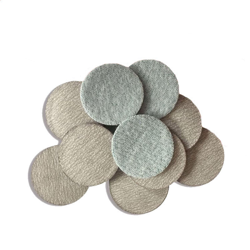 Comparison shot of coarse P60 and fine P1200 grit 75mm sanding pads for home DIY projects.