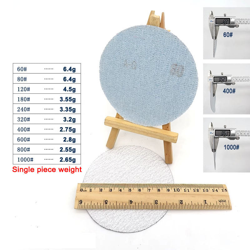 Macro shot of the abrasive surface of a P150 grit dry sanding pad, showing the sharp grain distribution for effective material removal.