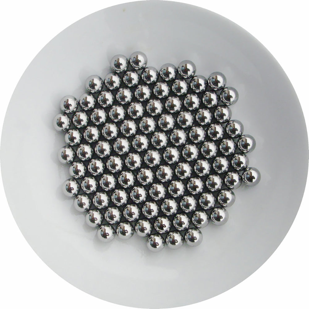 Size comparison of 7mm, 12mm, and 20mm carbon steel balls on a workbench