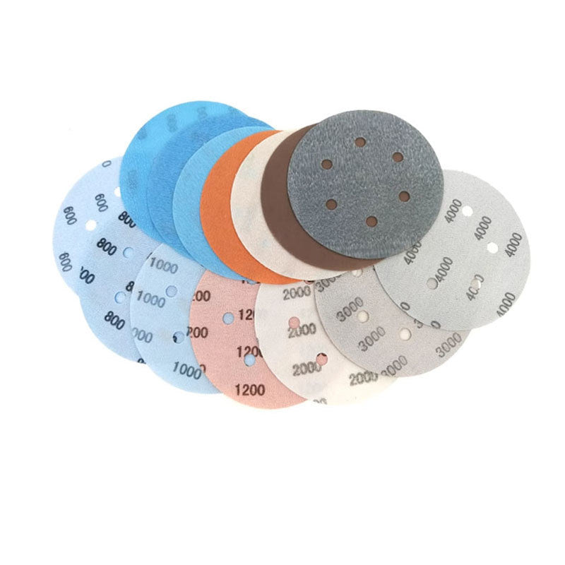 6-inch hook and loop sanding pad attached to a random orbital sander for DIY woodworking.