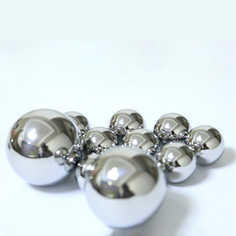 Single 31.75mm large diameter 440C steel ball held in hand for scale