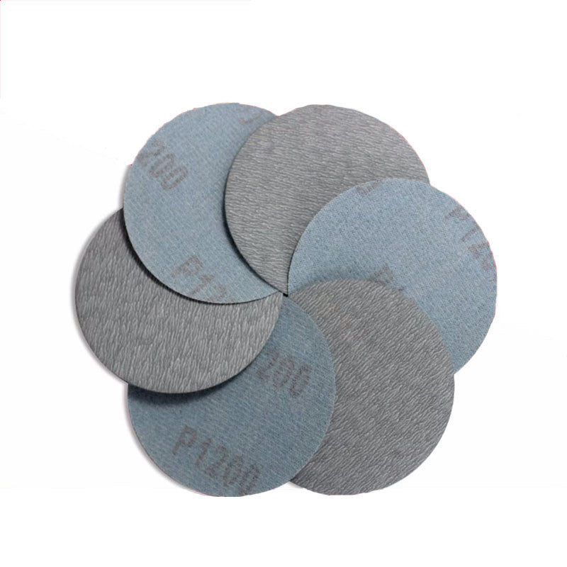 75mm sanding disc attached to a random orbital sander, ready for use on a woodworking project.